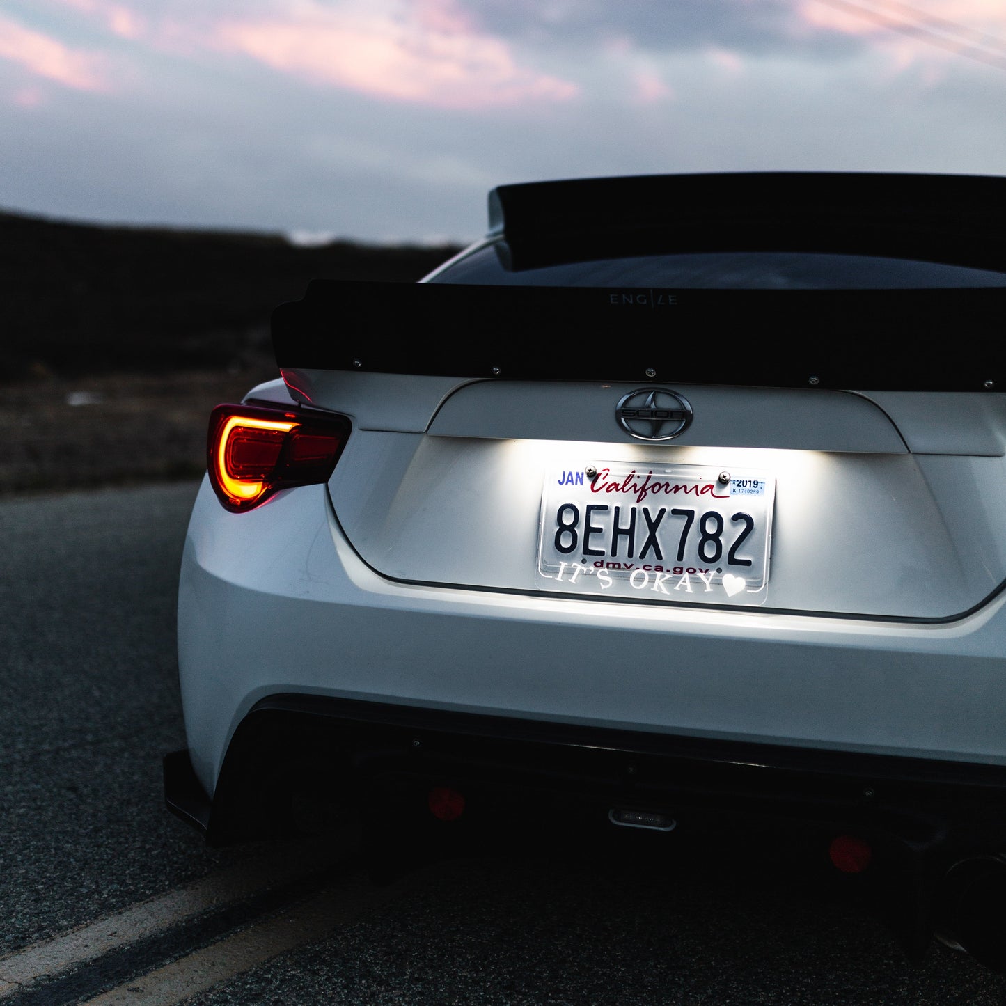 Back view of a car on a road with a California license plate