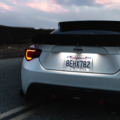 Back view of a car on a road with a California license plate