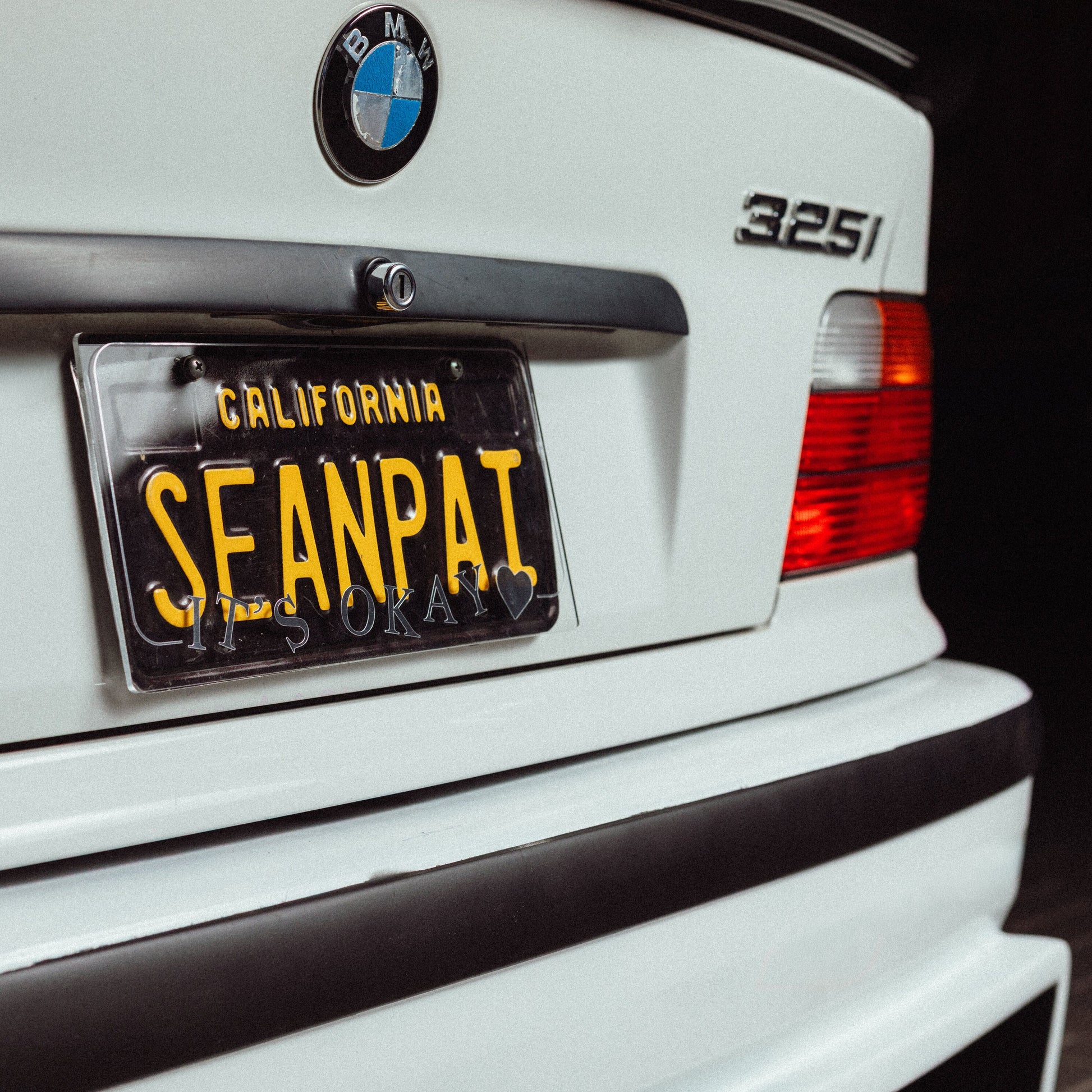 BMW car with a personalized license plate on a dark background (branding Itsokay)