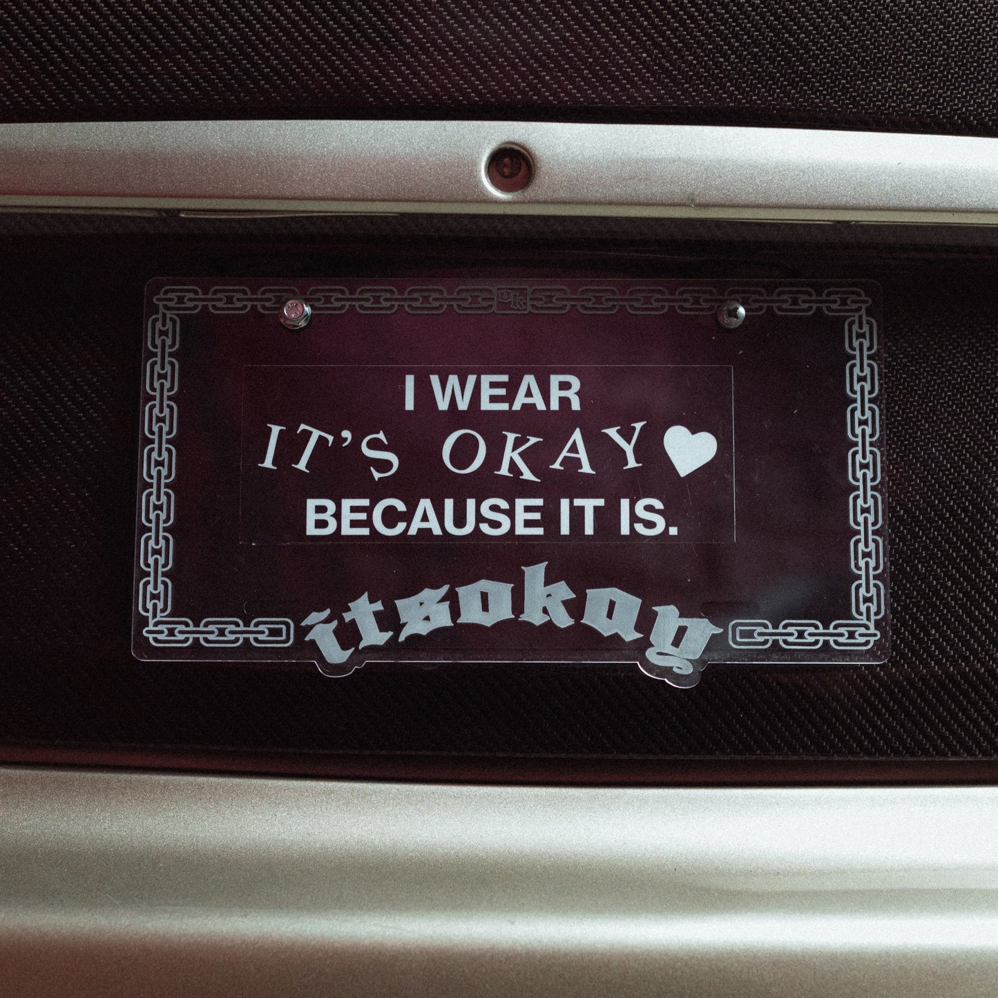 Decorative sticker with text on a car dashboard Branding ItsOkay