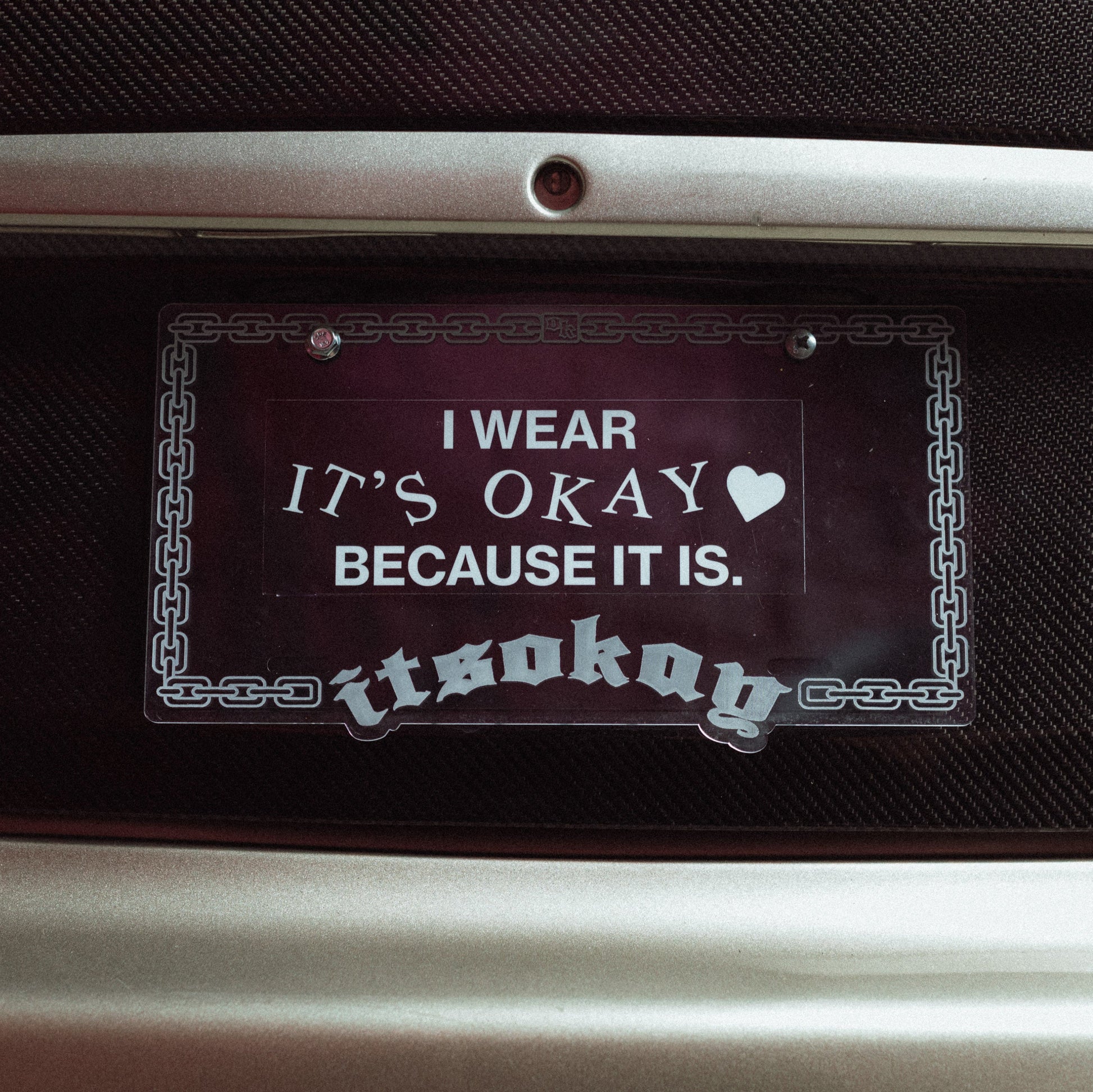 Decorative sticker with text on a car dashboard Branding ItsOkay