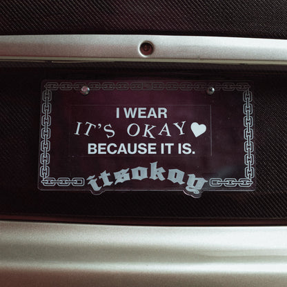 Decorative sticker with text on a car dashboard Branding ItsOkay